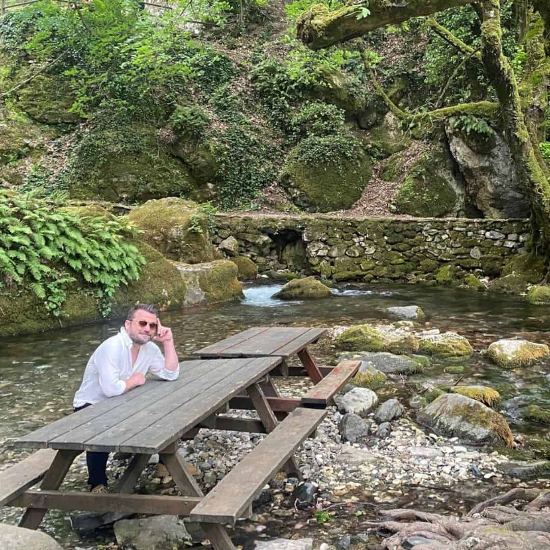 Marcus sitting at a picnic table by a waterfall stream in western Turkey